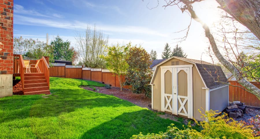 Fenced backyard with storage shed in Dover